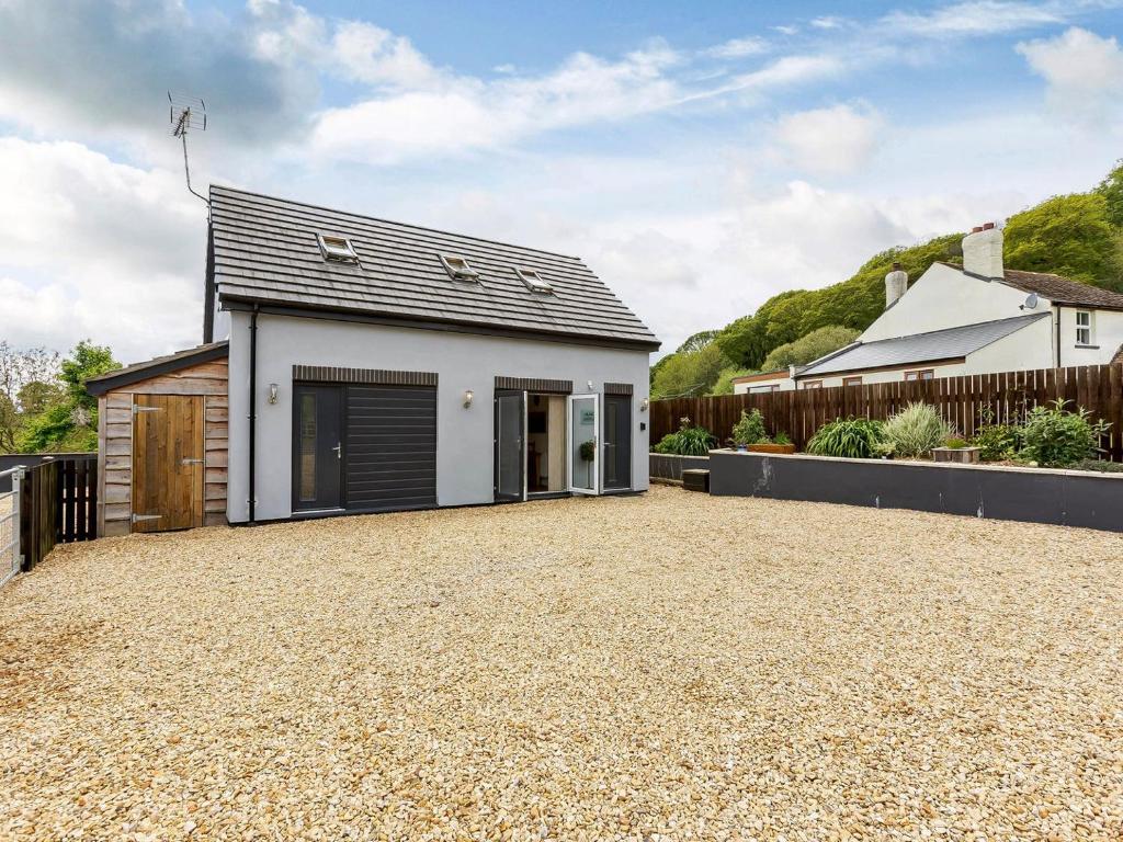 a detached house with a garage and a driveway at Lilac Lodge in Flaxley