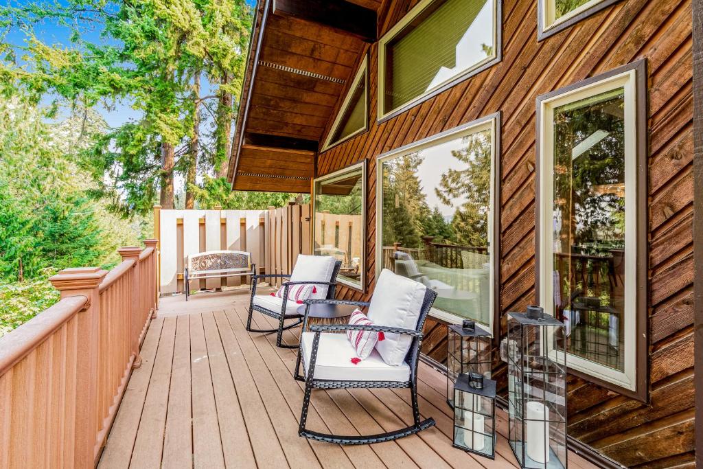 a wooden deck with two chairs and a table at The Treehouse in Bellingham