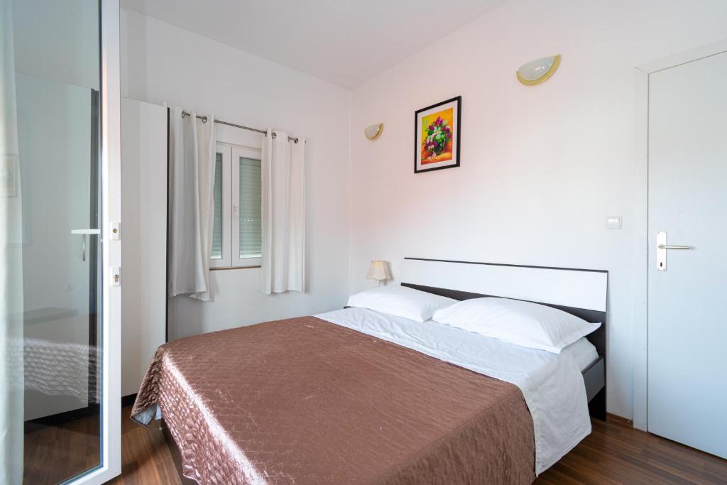 a bedroom with a large bed in a room at Apartments with a parking space Bibinje, Zadar - 18275 in Bibinje