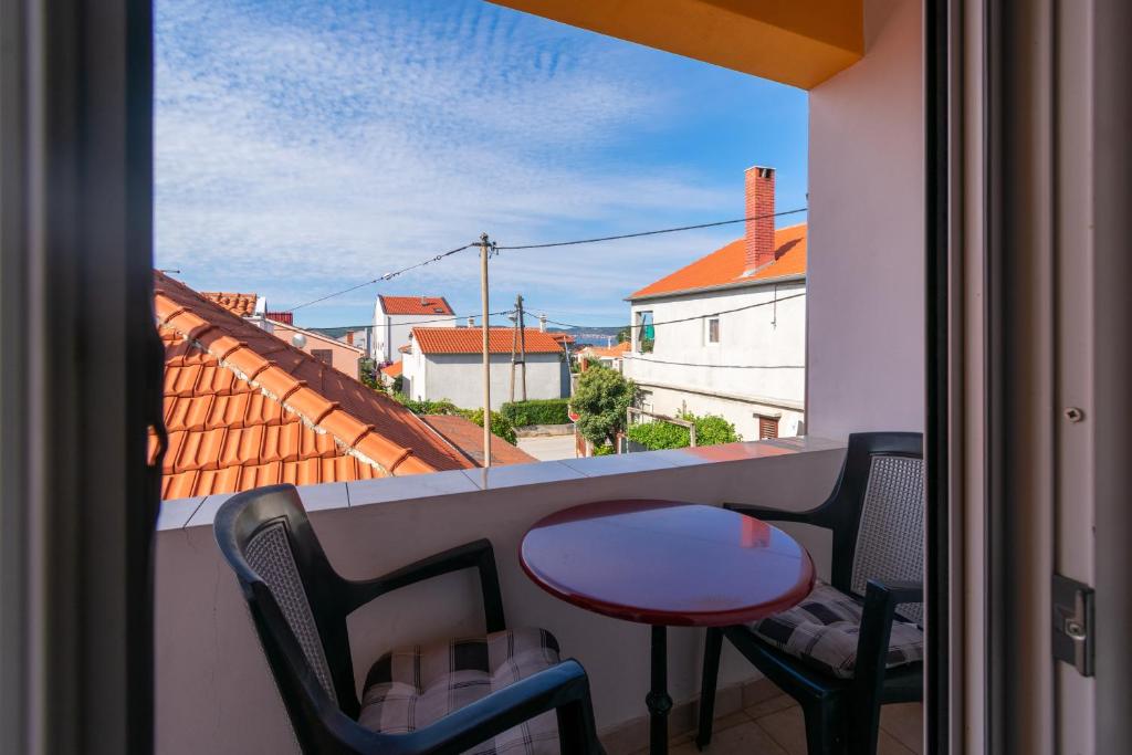 a balcony with a table and chairs and a view at Apartments with a parking space Bibinje, Zadar - 18275 in Bibinje