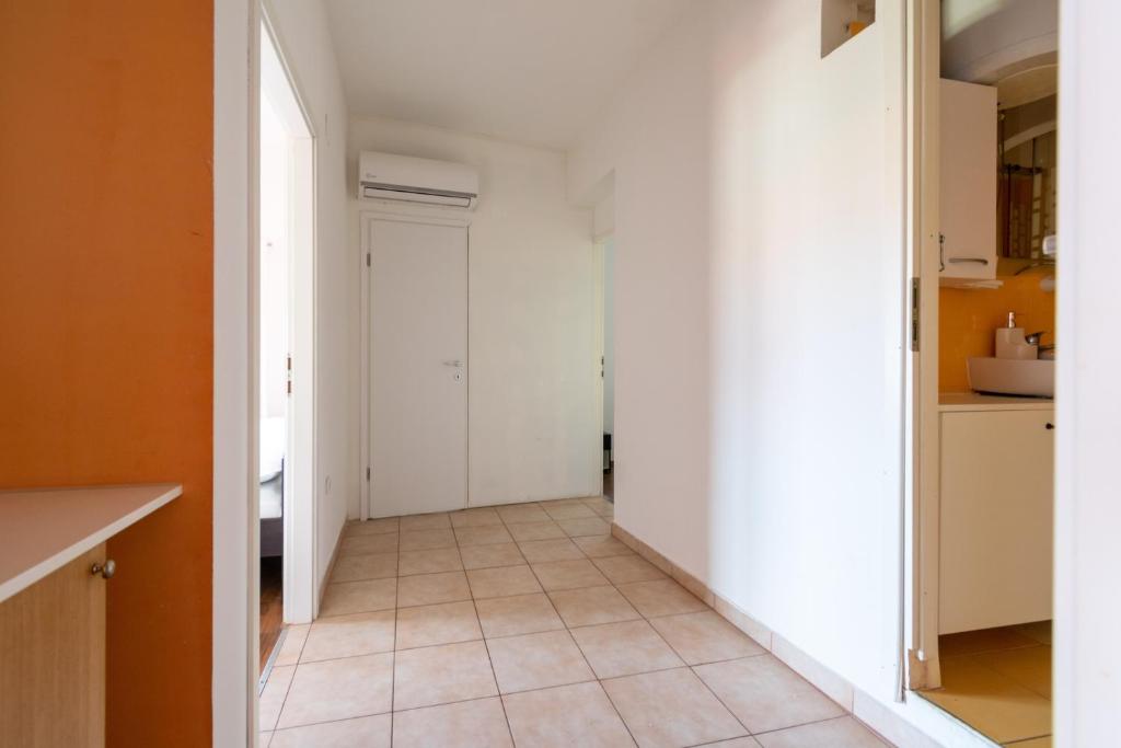 a hallway of a kitchen with white walls and a tile floor at Apartments with a parking space Bibinje, Zadar - 18275 in Bibinje