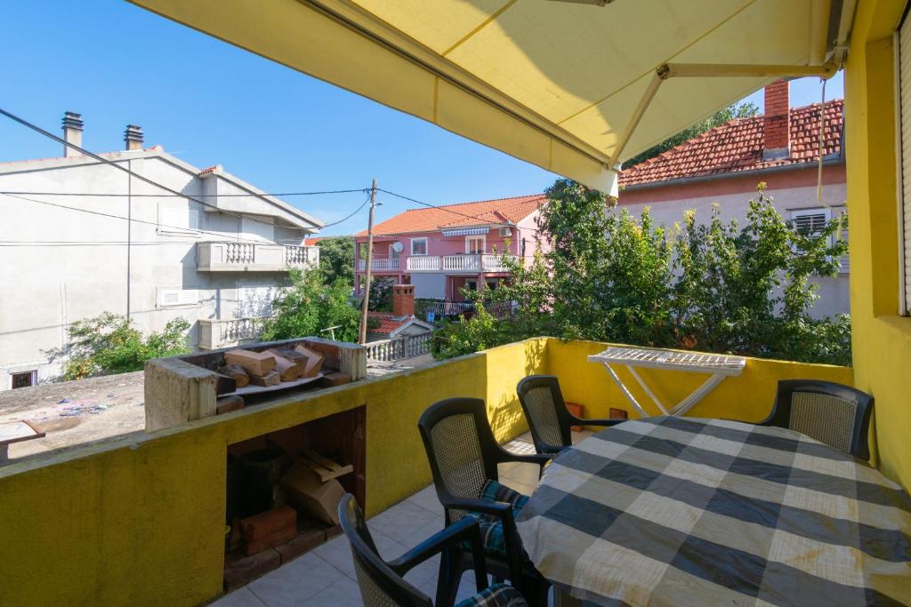 a patio with a table and chairs on a balcony at Apartments with a parking space Bibinje, Zadar - 18275 in Bibinje