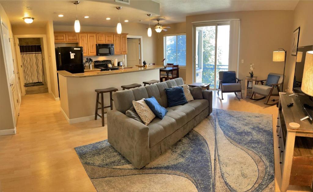 a living room with a couch and a kitchen at 1-Bedroom Condo in the Heart of the City in Salt Lake City