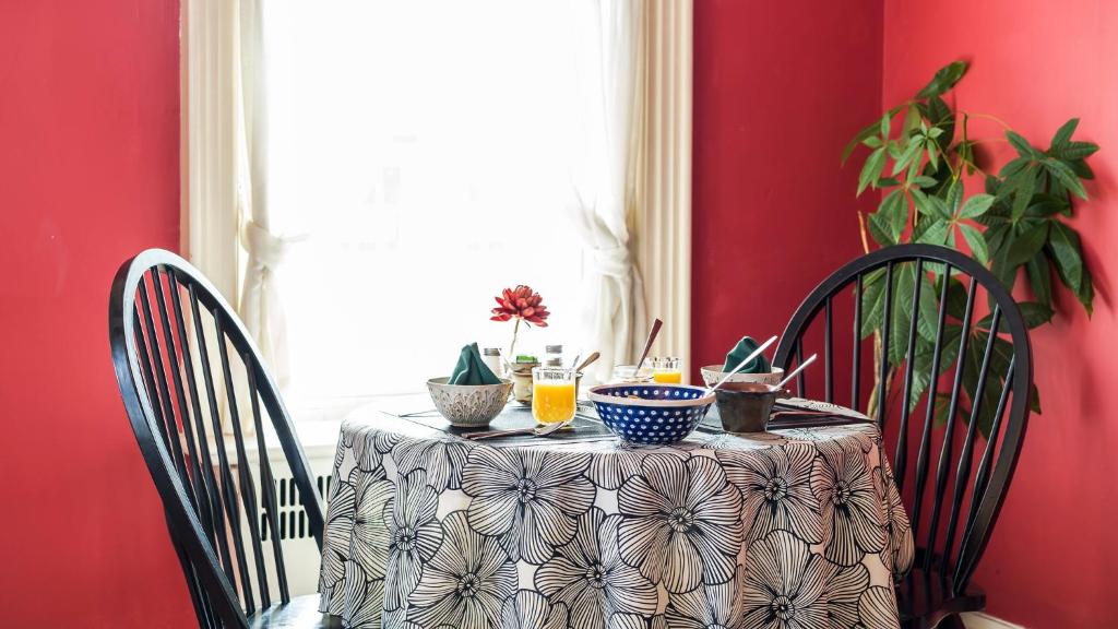 a table with a table cloth on it with two chairs at The Inn on Bay in Gravenhurst
