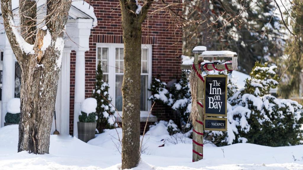 a sign in the snow in front of a house at The Inn on Bay in Gravenhurst