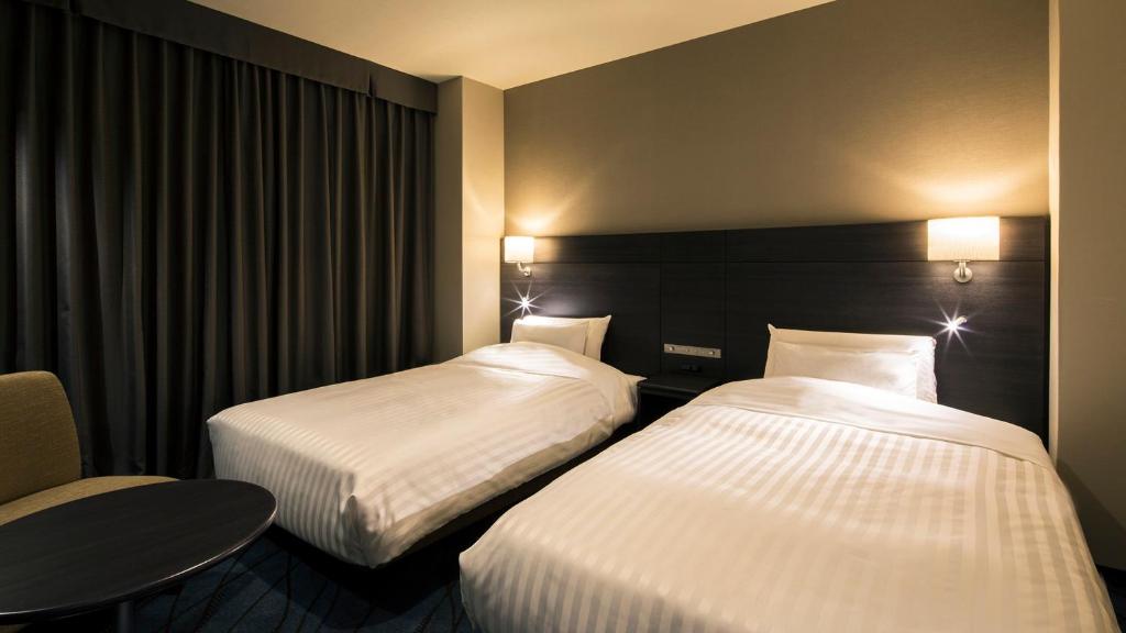 Postel nebo postele na pokoji v ubytování JR-East Hotel Mets Kawasaki
