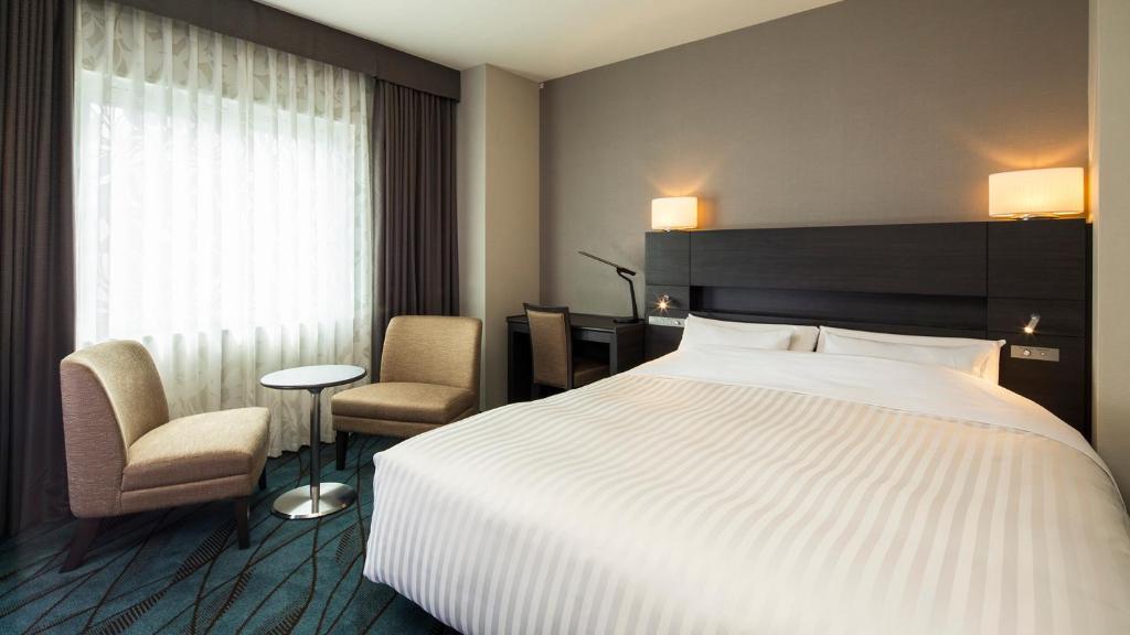Postel nebo postele na pokoji v ubytování JR-East Hotel Mets Kawasaki
