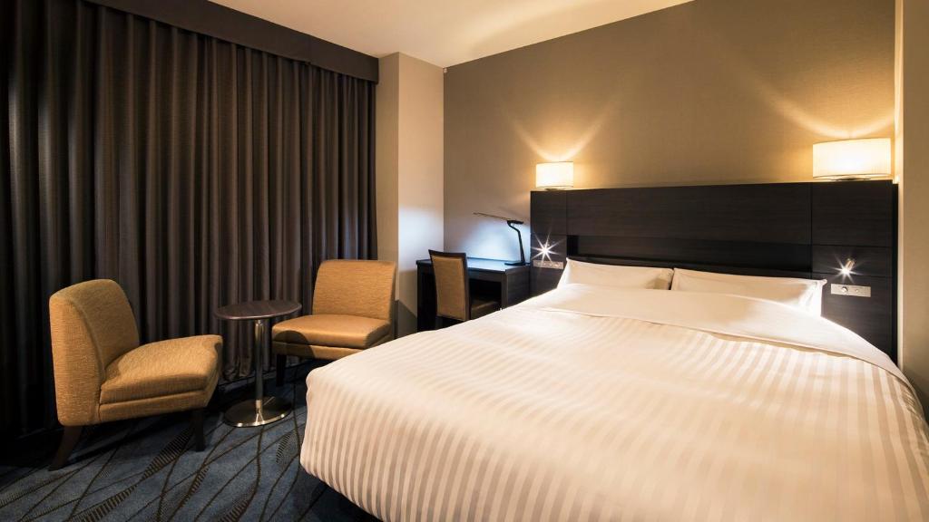 Postel nebo postele na pokoji v ubytování JR-East Hotel Mets Kawasaki
