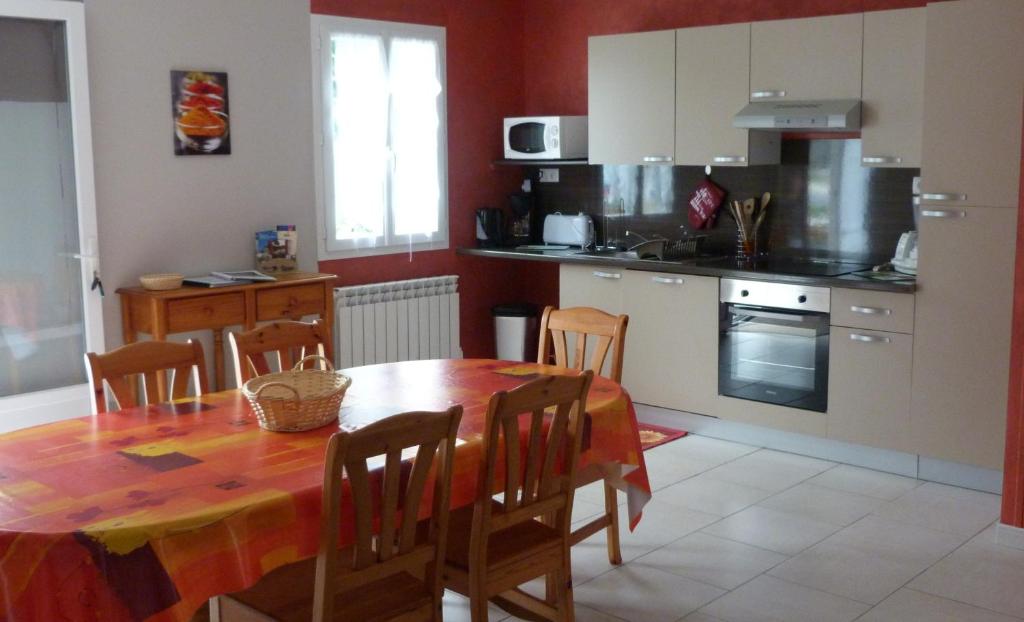 a kitchen with a wooden table and a dining room at Les Gites De Colliers in Muides-sur-Loire