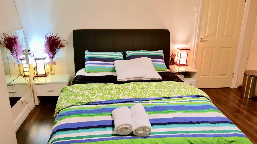 a bedroom with a large bed with towels on it at Central of CBD in Sydney