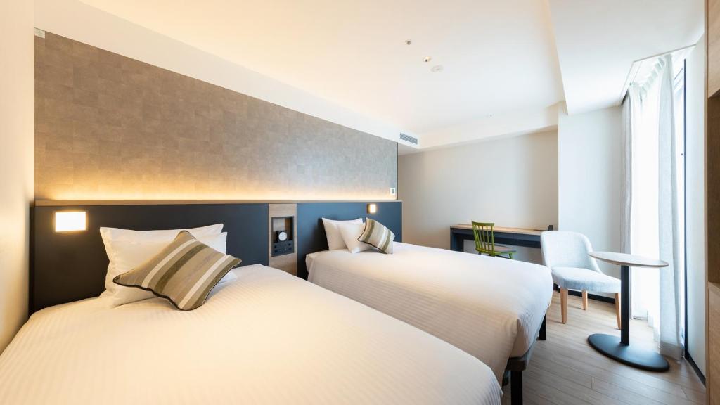 Postel nebo postele na pokoji v ubytování JR-East Hotel Mets Yokohama