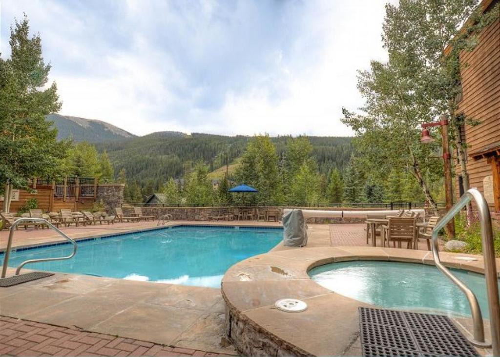 a swimming pool with a view of a mountain at Jackpine Lodge by Summit County Mountain Retreats in Keystone