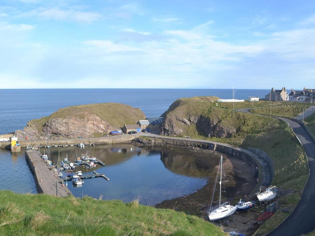 a group of boats in a marina in the water at White Gables - Uk30688 in Portknockie