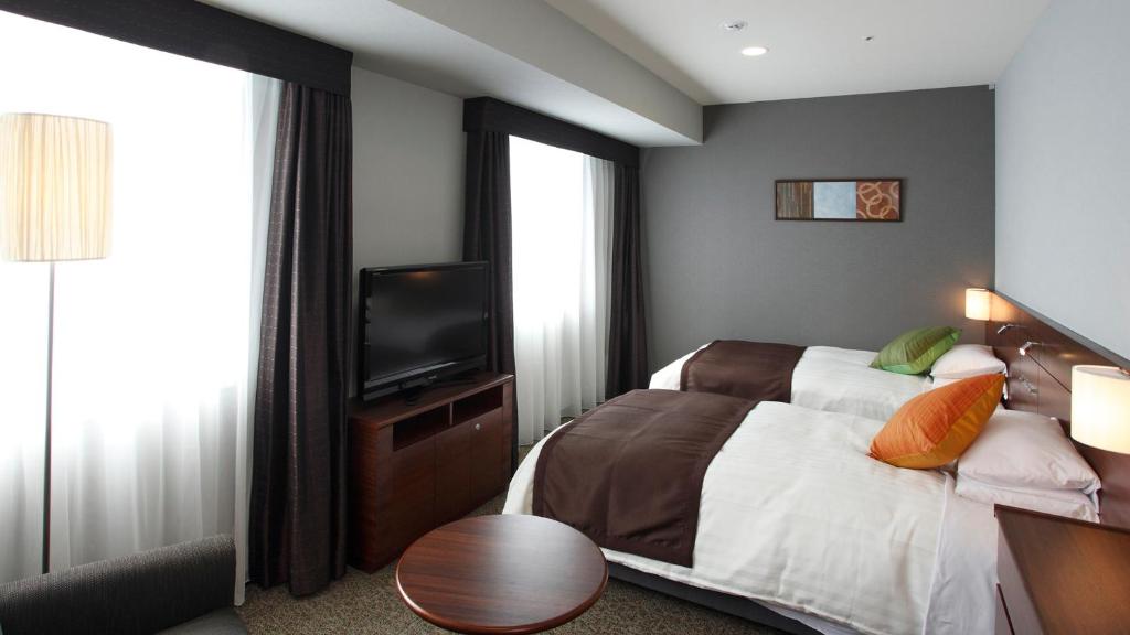 Postel nebo postele na pokoji v ubytování JR-East Hotel Mets Komagome