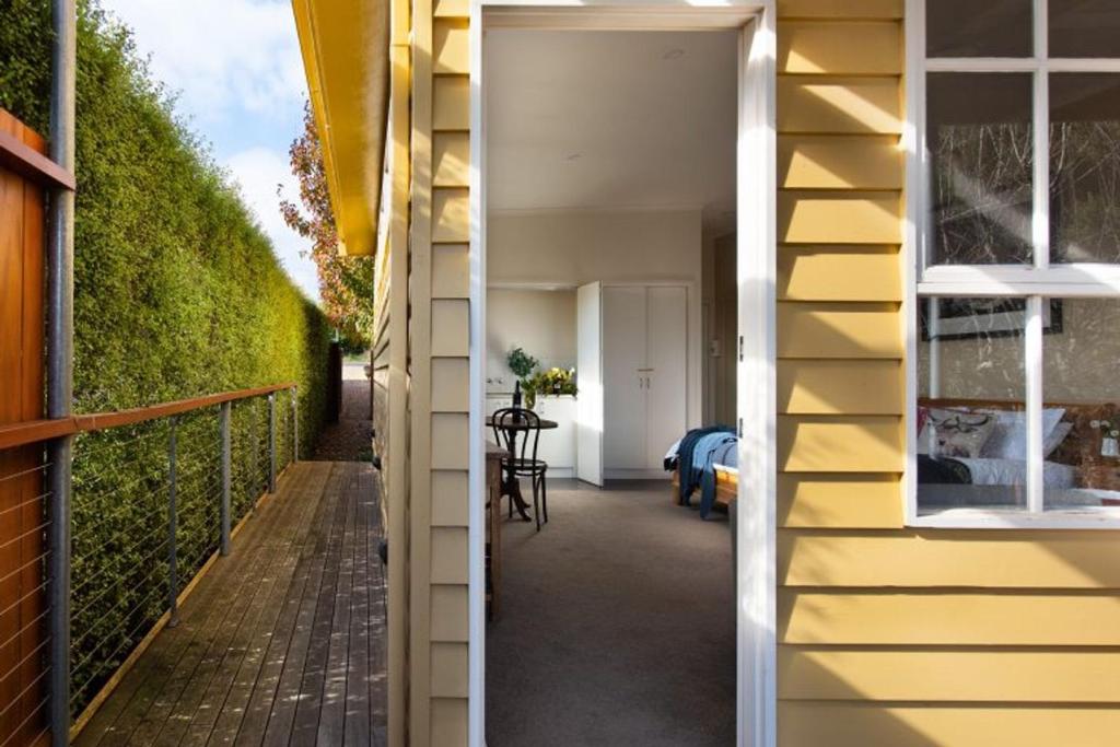 a hallway of a house with a yellow wall at Daylesford House Studio in Daylesford