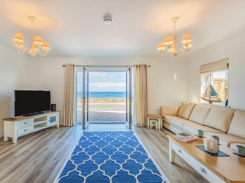 a living room with a couch and a view of the ocean at Headland View in Banff