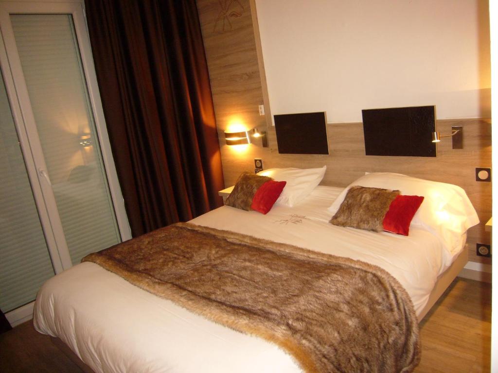 Postel nebo postele na pokoji v ubytování Hotel et Résidence Le Clos Cerdan
