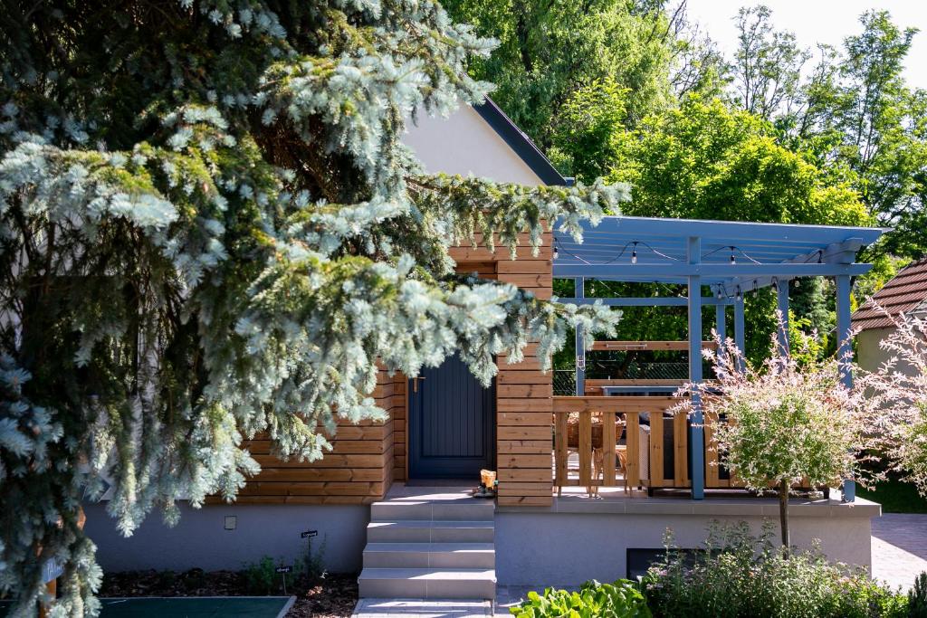 una casa con una puerta azul y un árbol en Kikapcsol-LAK, en Bogács