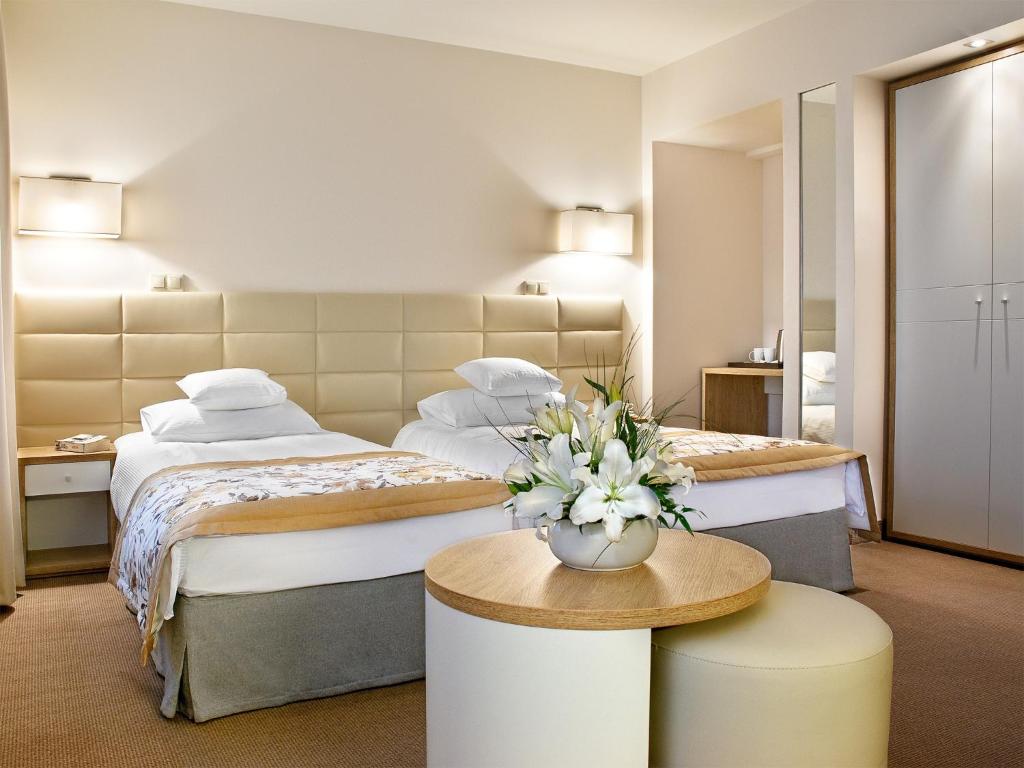 Postel nebo postele na pokoji v ubytování Hotel Petropol