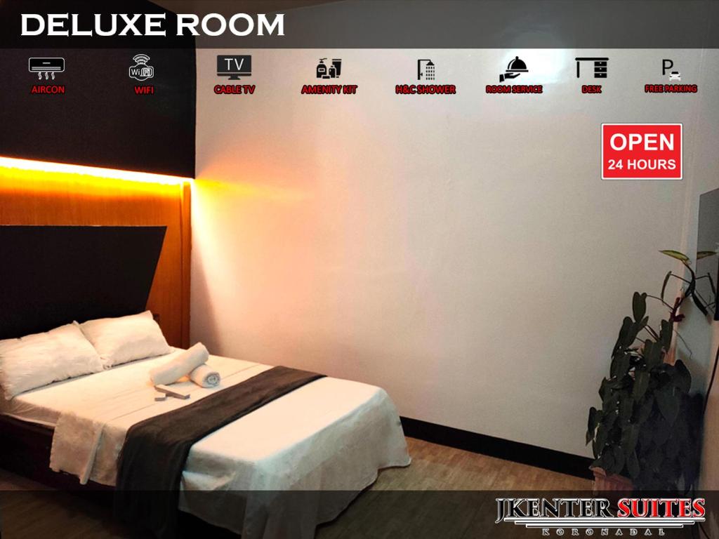 Postel nebo postele na pokoji v ubytování Jkenter Suites