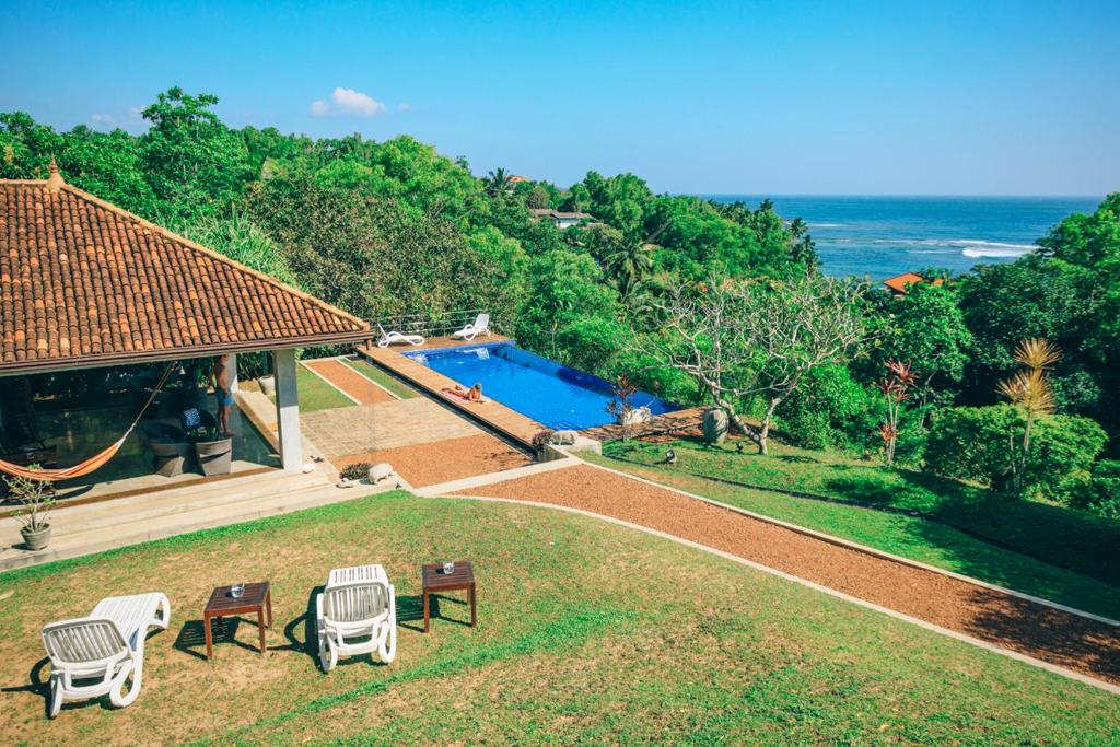 an aerial view of a house with a swimming pool at Highland Villa in Weligama