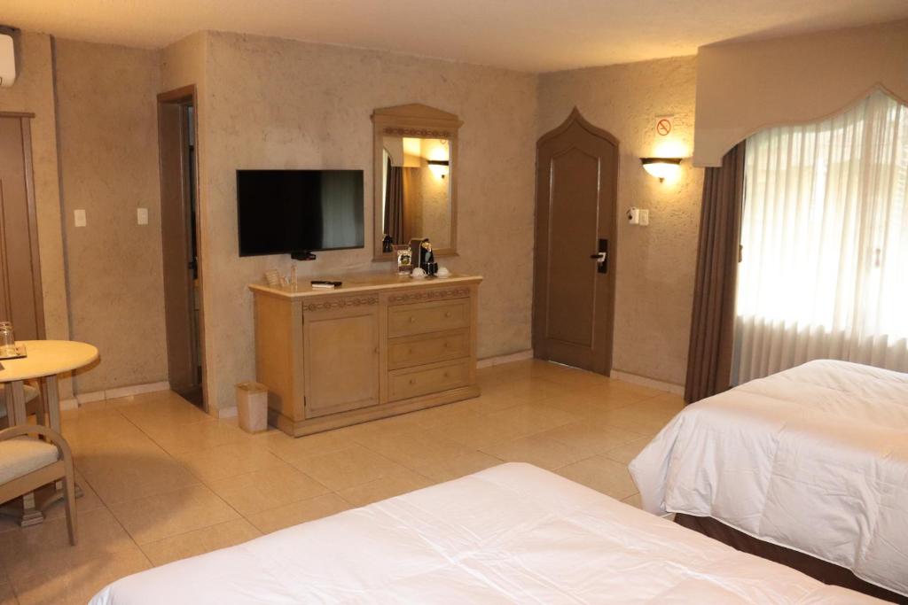 Postel nebo postele na pokoji v ubytování Suites Layfer, Córdoba, Veracruz, México