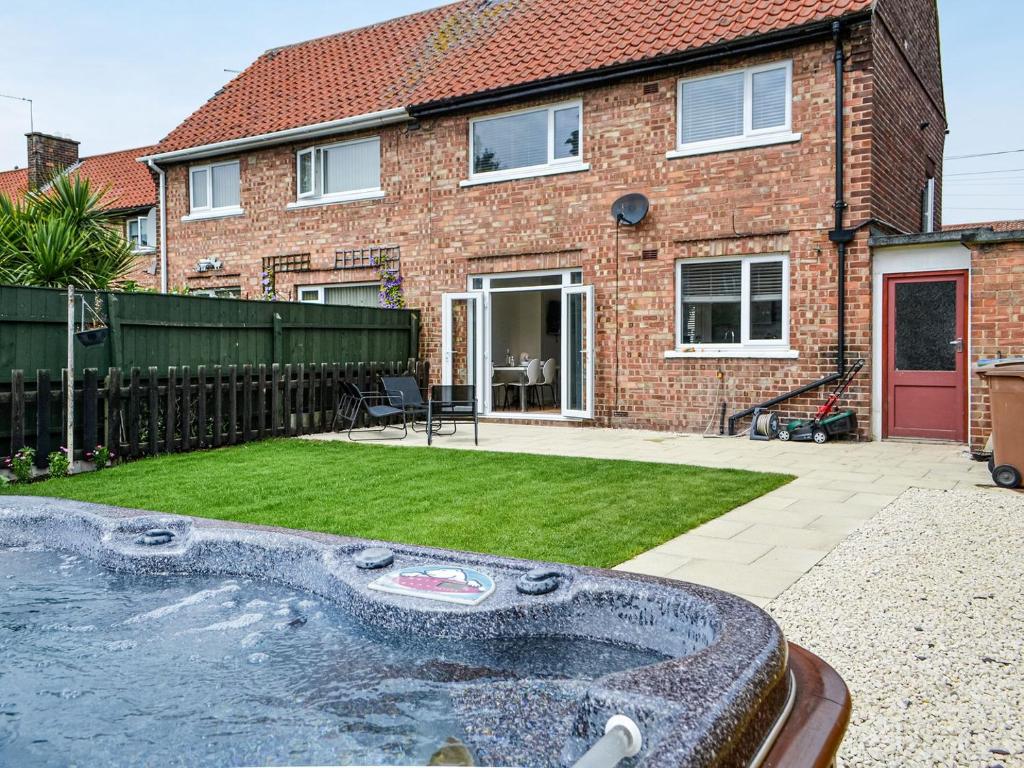 a brick house with a swimming pool in the yard at Goths Lane in Beverley