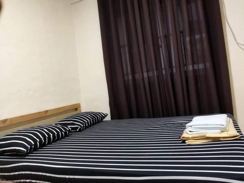 Postel nebo postele na pokoji v ubytování ABIZA Homestay