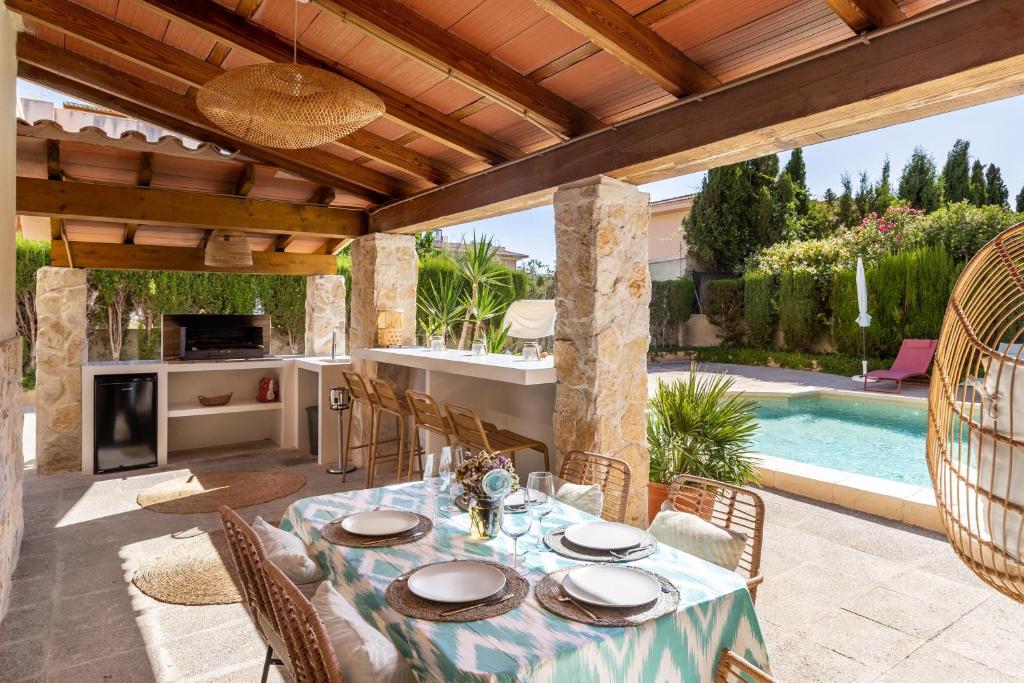 a patio with a table and chairs and a swimming pool at Villa Santa Lucia in El Toro