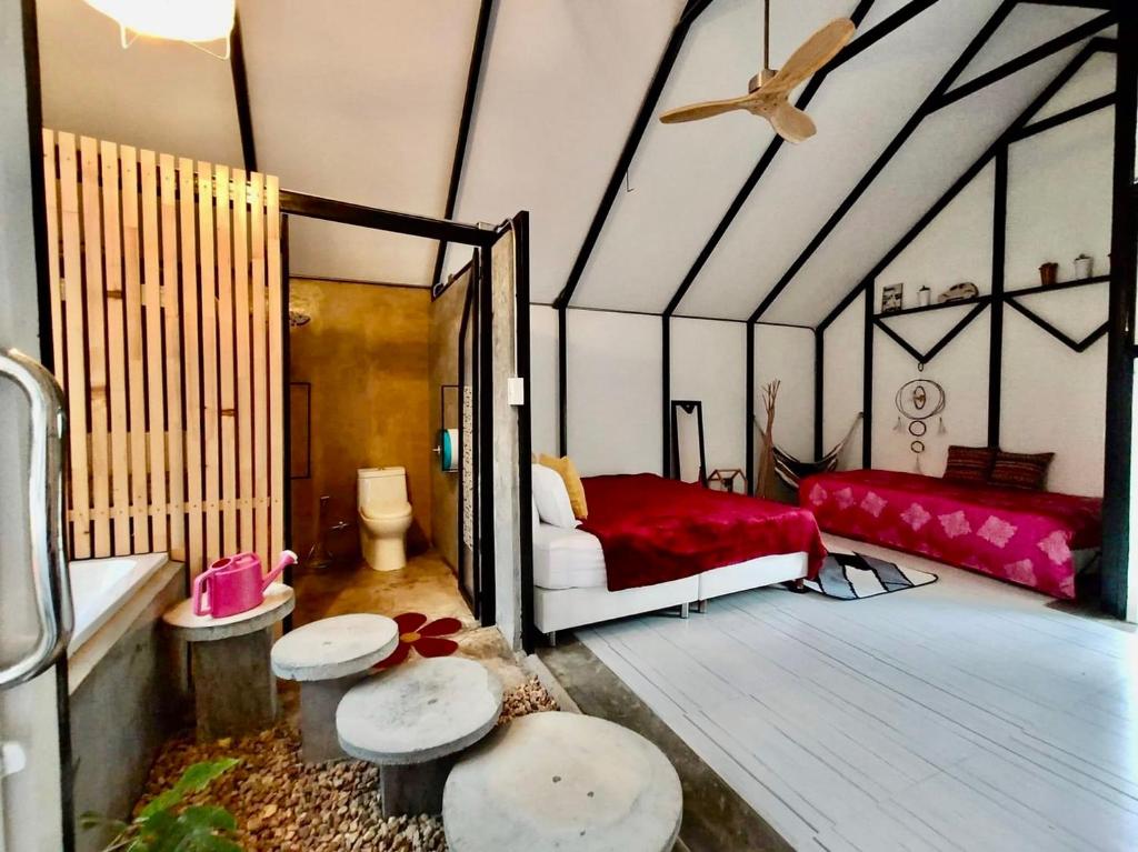 a room with a bedroom with a bed in it at See Sky at Na Rak O Resort in Chiang Rai