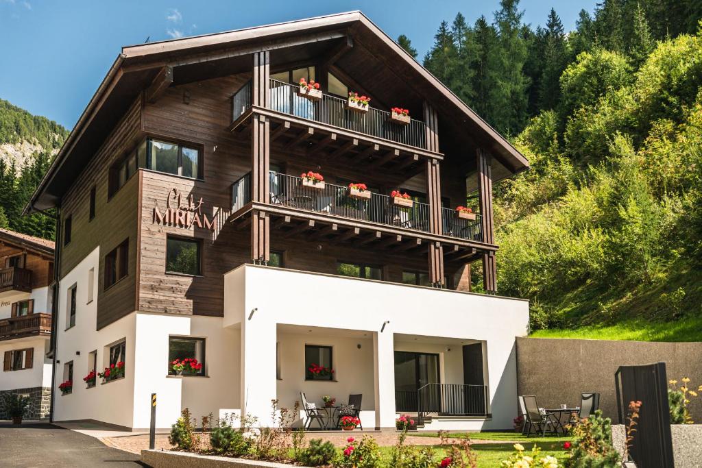 a large wooden building with a balcony at Chalet Miriam in Selva di Val Gardena