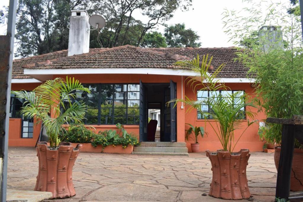 a small orange house with plants in front of it at Sochati Casa Resort in Nairobi