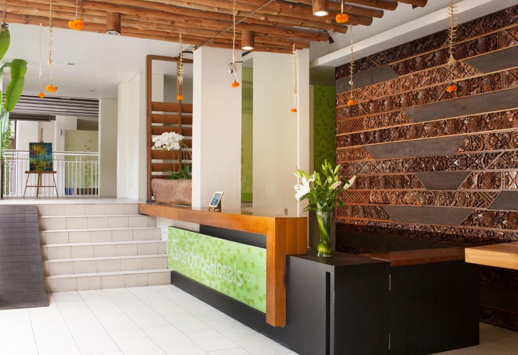 a brick wall in a restaurant with a counter at Grandmas Plus Hotel Seminyak in Seminyak