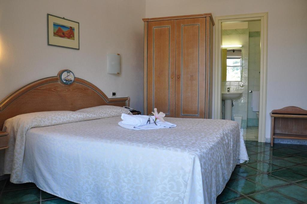 a bedroom with two beds with towels on the bed at Hotel La Marticana in Ischia