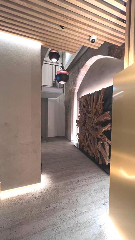 a hallway in a building with a ceiling with lights at Hotel Centre Reus in Reus