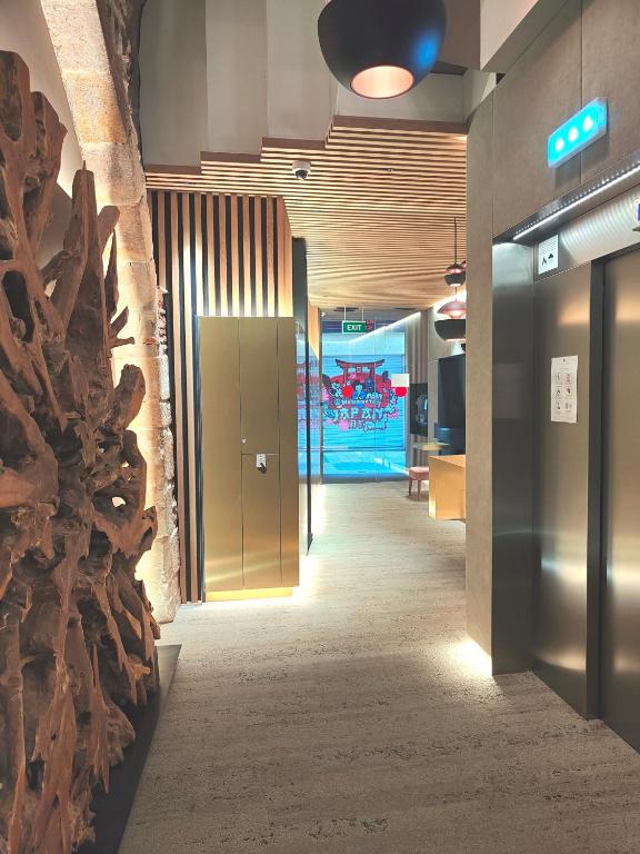 a hallway in an office building with a wall of logs at Hotel Centre Reus in Reus