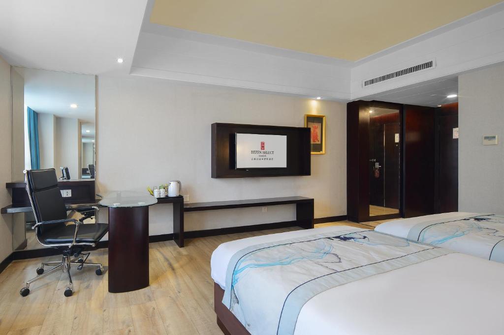 Postel nebo postele na pokoji v ubytování Foshan Rezen Select Pasonda Hotel