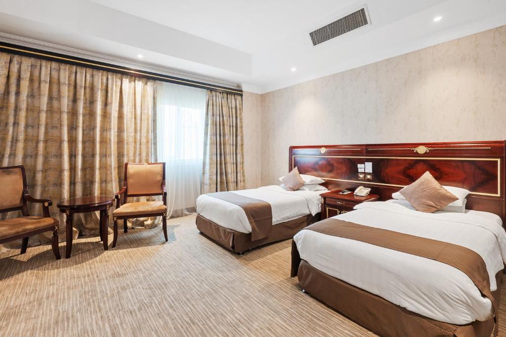 Krevet ili kreveti u jedinici u okviru objekta Chairmen Hotel