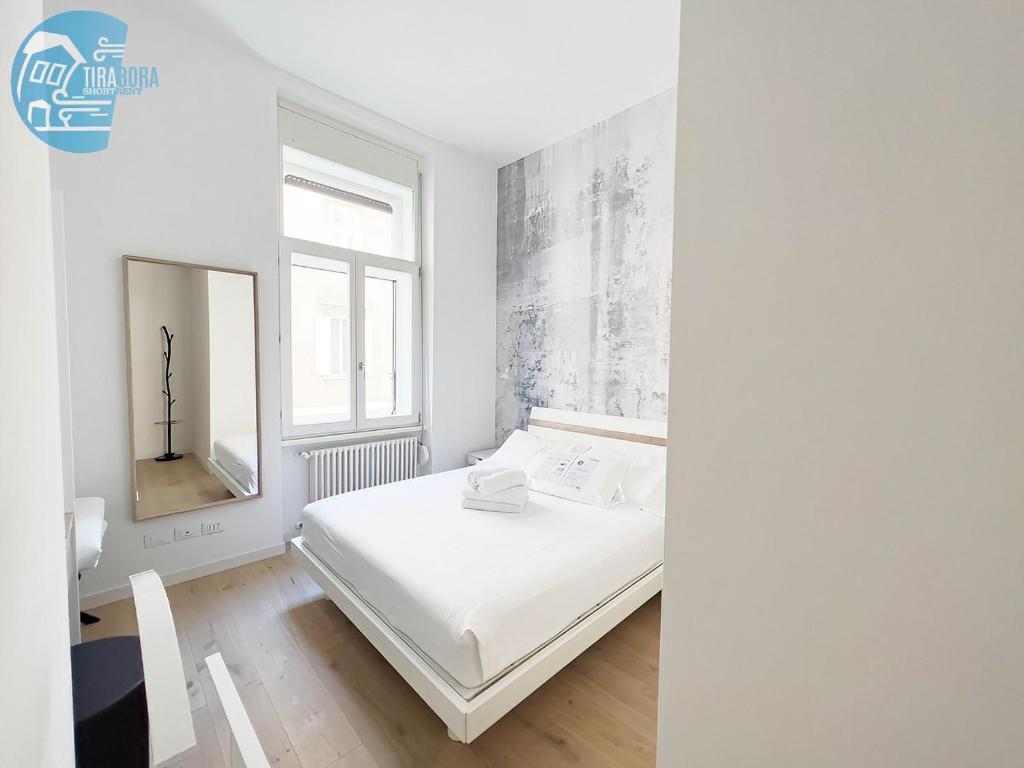 A bed or beds in a room at San Lazzaro 232 Tirabora Short Rent