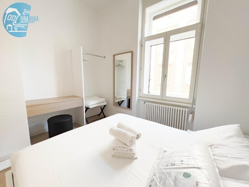 A bed or beds in a room at San Lazzaro 232 Tirabora Short Rent