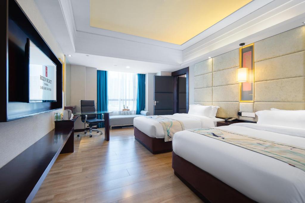 Postel nebo postele na pokoji v ubytování Foshan Rezen Select Pasonda Hotel