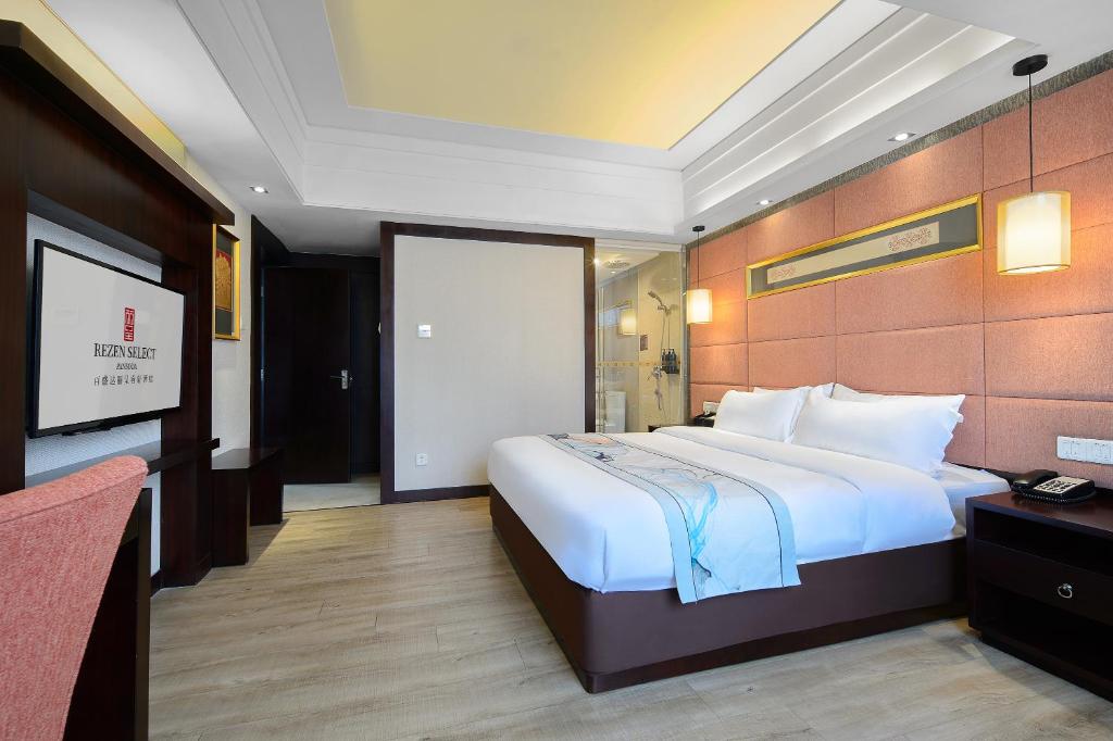 Postel nebo postele na pokoji v ubytování Foshan Rezen Select Pasonda Hotel