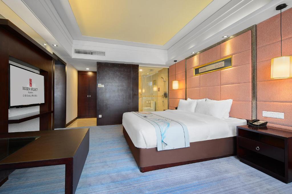 Postel nebo postele na pokoji v ubytování Foshan Rezen Select Pasonda Hotel
