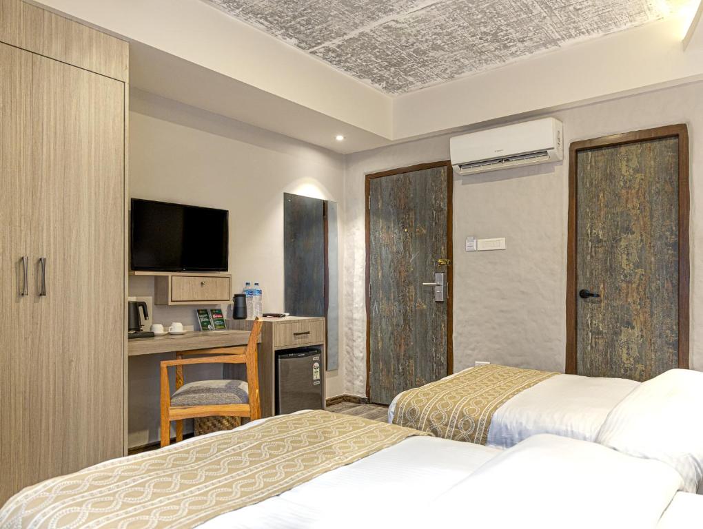 Postel nebo postele na pokoji v ubytování Vastu Boutique Hotel