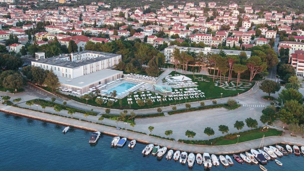 an aerial view of a marina with boats in the water at Falkensteiner Hotel Park Punat in Punat