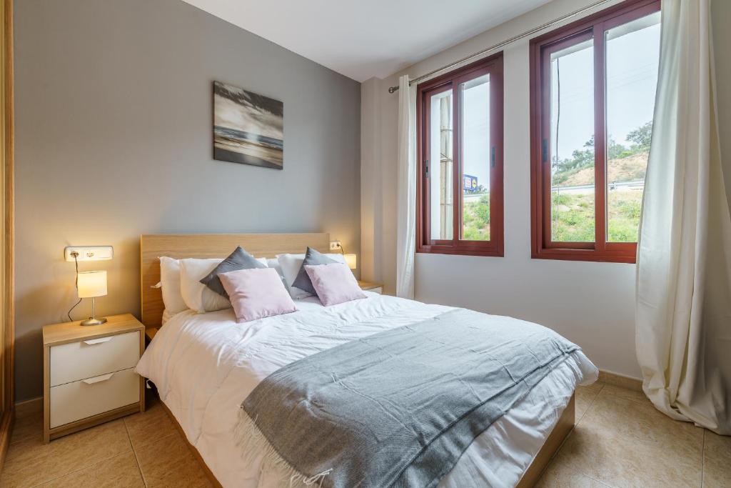a bedroom with a large bed with two pillows at CT 143 - La Cala Boulevard - Apartement II in La Cala de Mijas