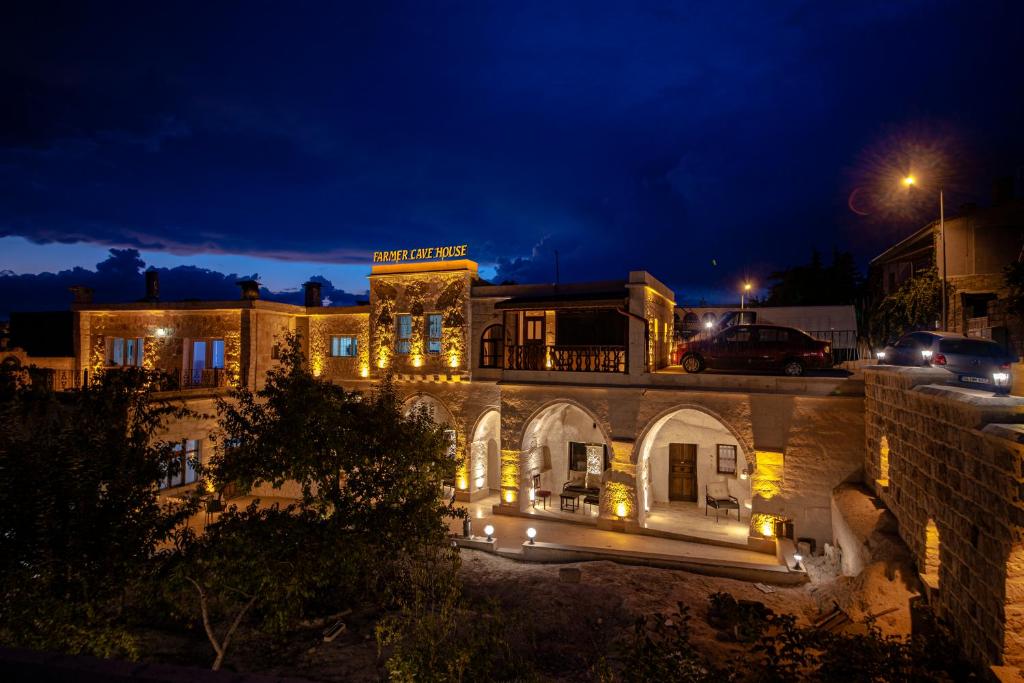 a building with lights on it at night at FARMER CAVE HOUSE in Ürgüp