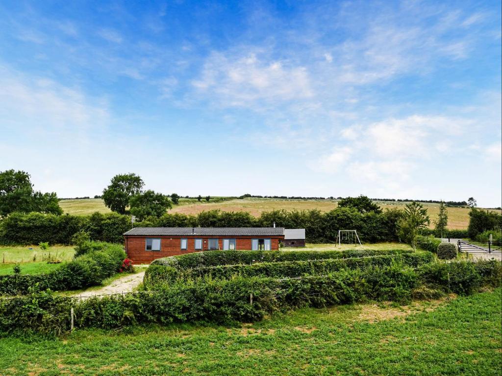 a house in the middle of a field at The Lodge in Great Easton