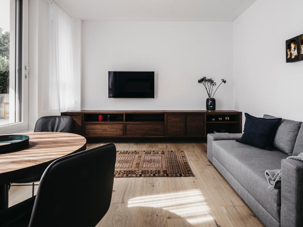 a living room with a couch and a table at Das Dietrich - Studio Saillerhof in Leibnitz