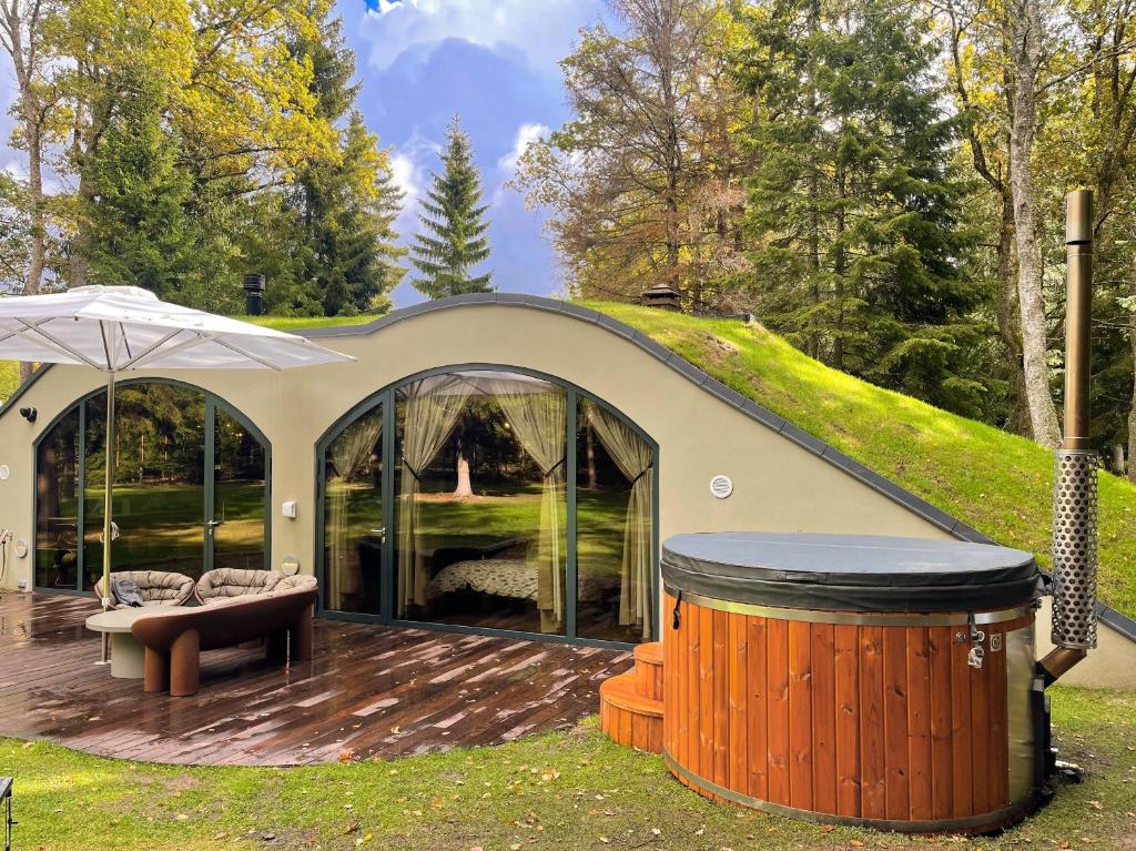 a gazebo with a bench and an umbrella at Silma Retreat in Haapsalu